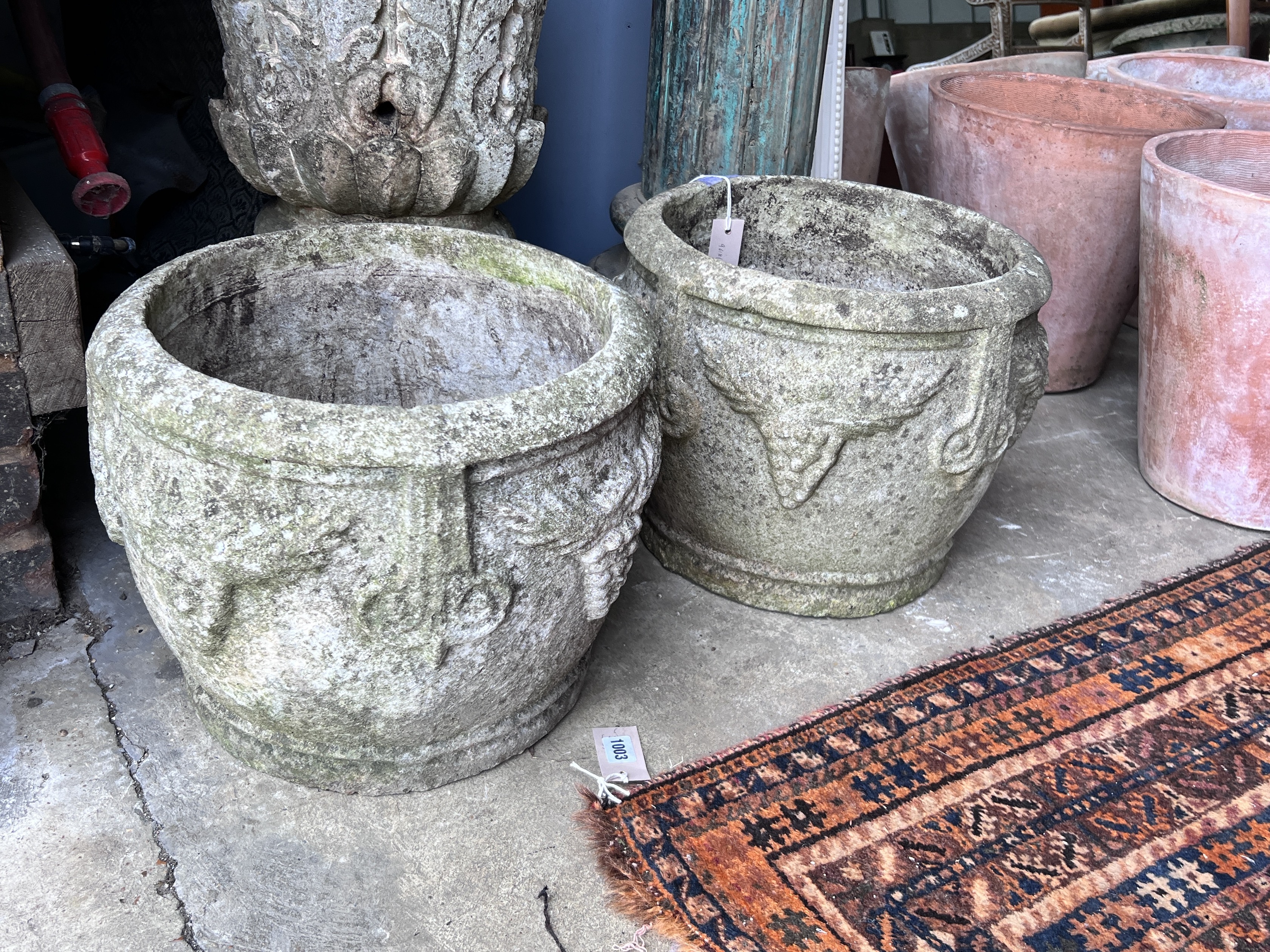 A pair of circular reconstituted stone garden planters, diameter 37cm, height 31cm